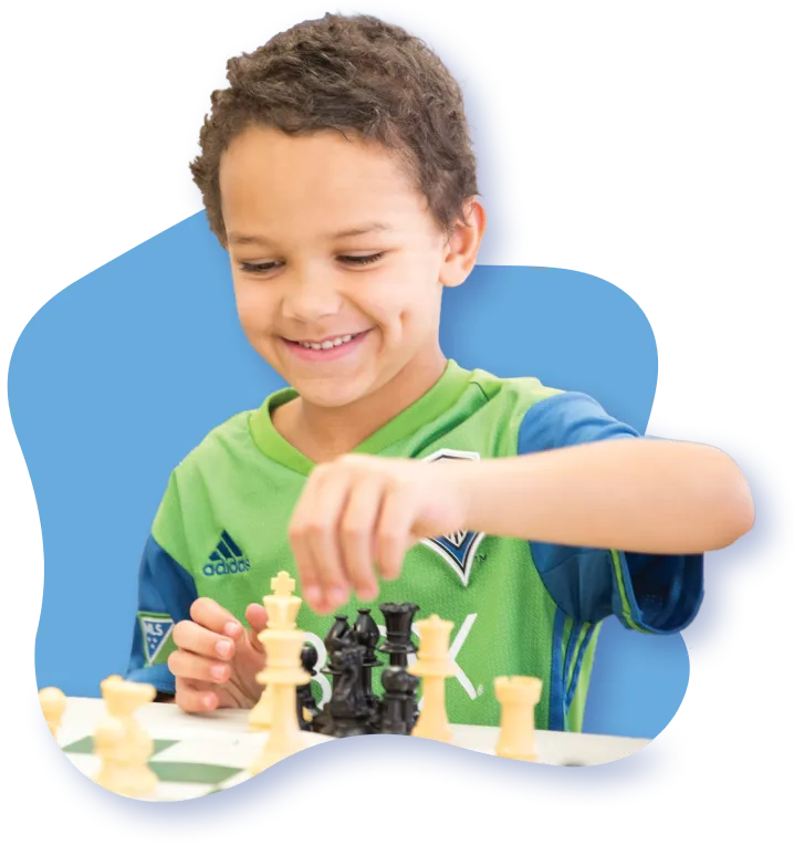 smiling boy playing chess